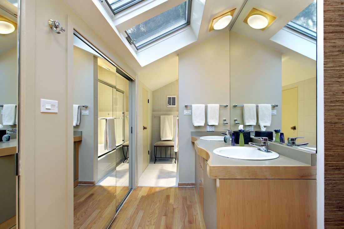 Skylights and solar tubs bring welcome sun into a bathroom with no wall windows. Installed by Spring Hill Roofers.